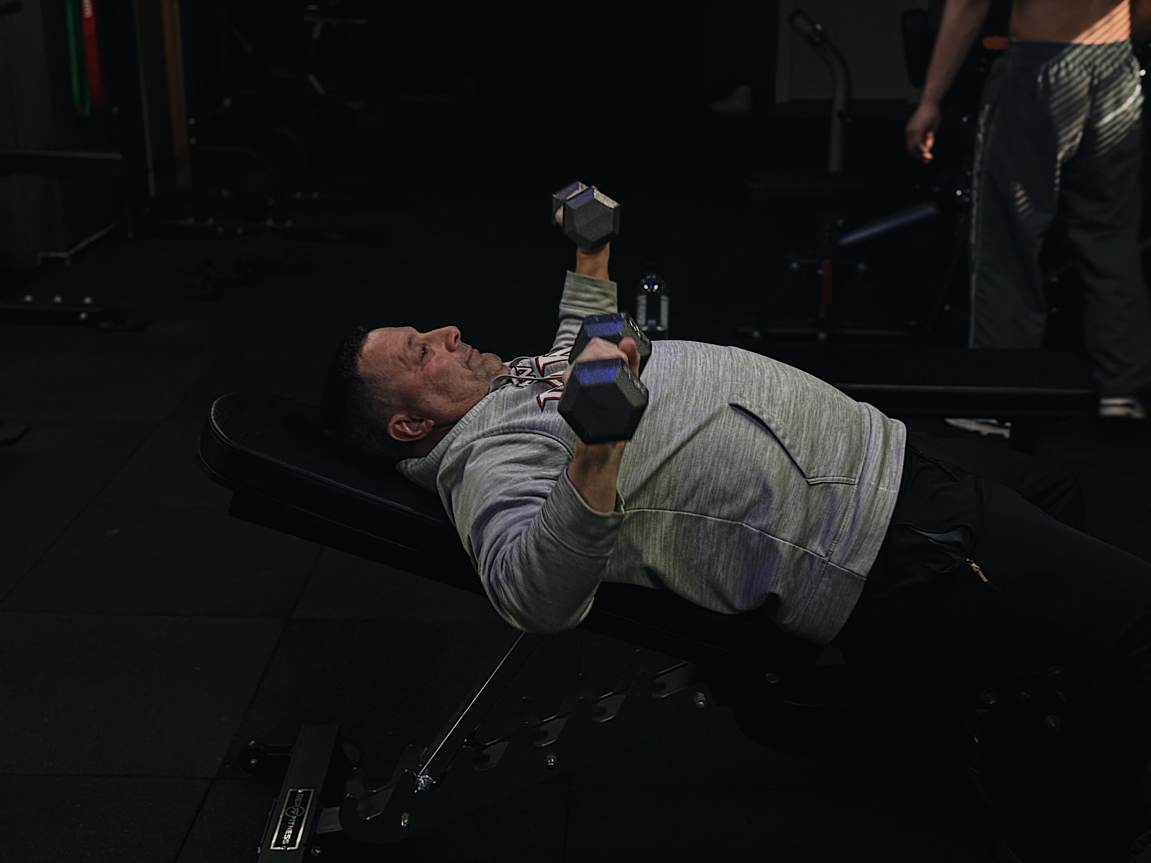 Middle-aged client strength training with a BAM Fitness trainer