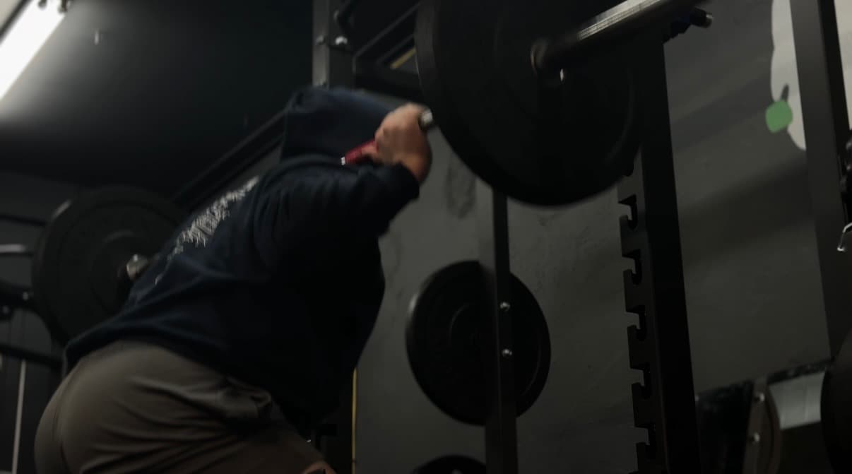 BAM Fitness client performing a barbell squat during strength training in Dumont, NJ